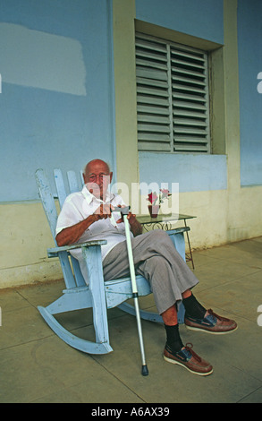 Person Sitting In Rocking Chair Elderly man sitting in rocking chair by a window, reading book Stock ...