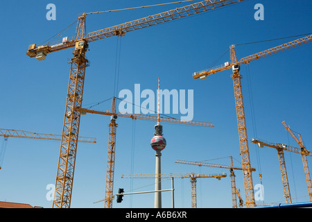 Cranes surround the Fernsehturm in the middle of Berlin in Germany Stock Photo