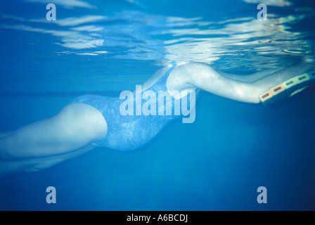 Pregnant woman swimming in pool Stock Photo