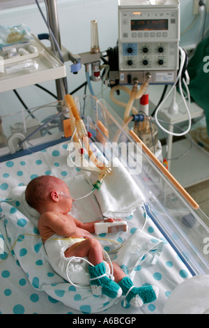 Premature little baby in an incubator at the neonatal section of the ...