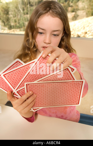 Portrait of Caucasian girl playing cards Stock Photo