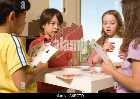 Portrait of kids playing cards Stock Photo