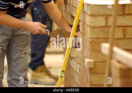 British bricklayer London brick wall UK apprentice building site Stock Photo