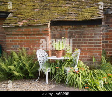 Wrought Iron Table and Chairs in a Garden Stock Photo