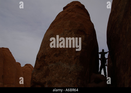 son on fathers shoulders in between sandstone monoliths Stock Photo