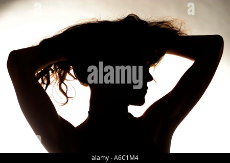 silhouette of young woman with hair up Stock Photo