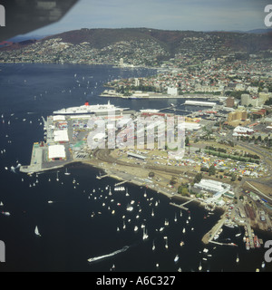 Aerial view from low flying plane over Hobart with yachts moored and docks in foreground liner docked at waterfront Tasmania Stock Photo