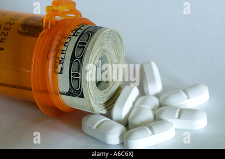 closeup view of pill bottle with pills and dollar bills Stock Photo