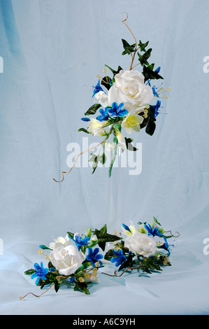 Three sprays of Sugar icing flowers for the top of a wedding cake standing in and around a bud vase design by Pam Hannon Stock Photo