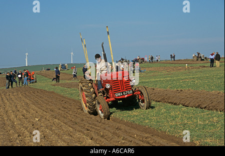 RHOSGOCH CEMAES ANGLESEY NORTH WALES UK March Vintage red tractor pulling a vintage plough Stock Photo