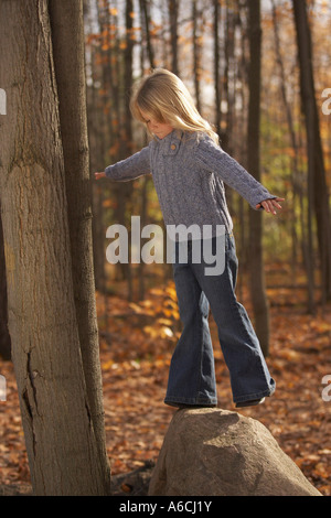 Girl Standing on Rock Stock Photo