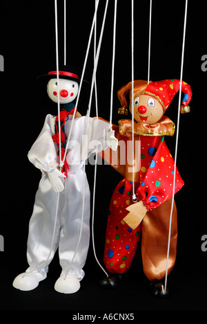 Clown Marionette puppets on strings dancing with a black background ...