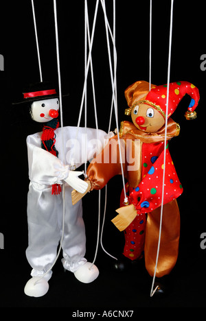 Clown Marionette puppets on strings dancing with a black background ...