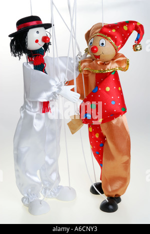 Marionette clown Puppets on a string about to hug on white background Stock Photo