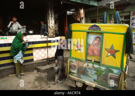 Pakistan Swat Valley Mingora Bazaar decorated rickshaw outside chai tea stall Stock Photo