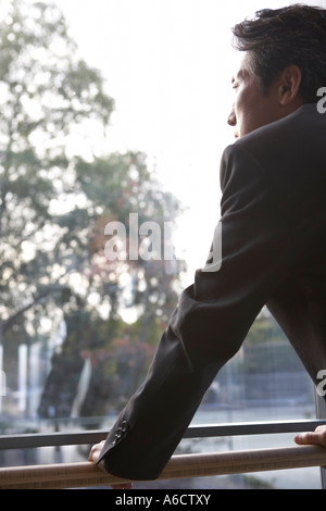 Businessman Looking Out Window Stock Photo