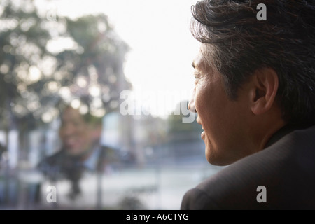 Businessman Looking Out Window Stock Photo