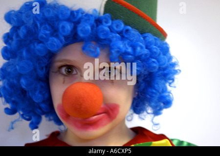 carnival karneval clown kid girl youth female lass funny humour comic dressing up fancy dress costume day daylight blue sky happ Stock Photo