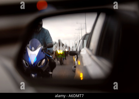 MOTORBIKES CREEP BETWEEN LINES OF CARS IN A TRAFFIC JAM FOLLOWING A POLICE INCIDENT ON THE M6 NORTH OF BIRMINGHAM UK Stock Photo