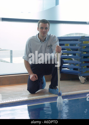 Carrying out routine tests on water quality in an indoor swimming pool. Stock Photo