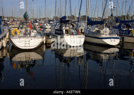 Three yachts moored in Chichester Marina, Sussex Stock Photo