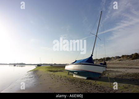 Beached yacht at dawn, East Head beach, Sussex, England Stock Photo