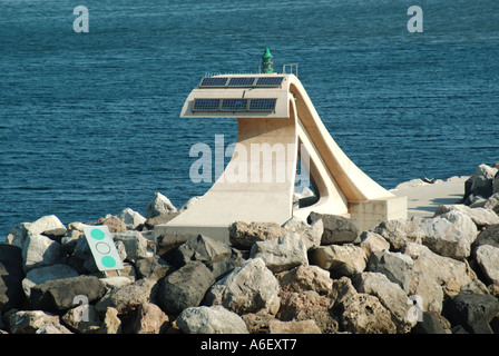 Sete port entrance green channel marker & solar panels for power harbour breakwater protected by massive precast concrete blocks Stock Photo