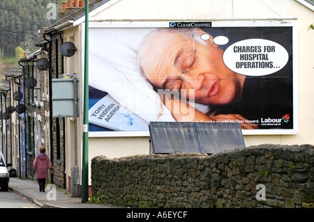 Labour Party election poster depicting Conservative leader Michael Howard asleep positioned on the end of terraced house in UK