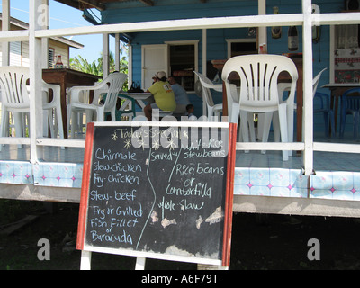 BELIZE Caye Caulker Menu on chalkboard at Glendas cafe and restaurant local eatery tables and chairs on porch Stock Photo