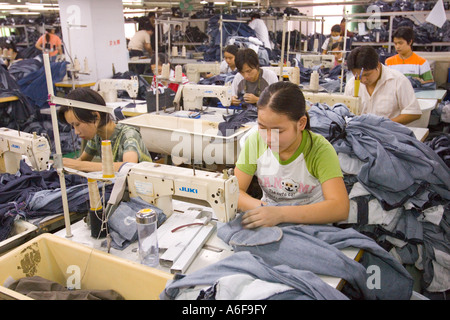 SHENZHEN GUANGDONG PROVINCE CHINA Workers sewing Mango jeans in garment factory in city of Shenzhen Stock Photo