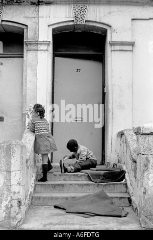 Children playing outside house in Notting Hill Gate London Uk 1975. Stock Photo