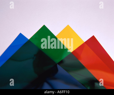 Overlapping sheets of transparent coloured plastic film. Stock Photo