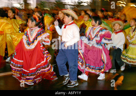 Hispanic children dancing singing in Chinese New Year parade San Francisco California Stock Photo