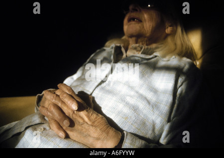 Elderly woman with hands folded on chest Stock Photo