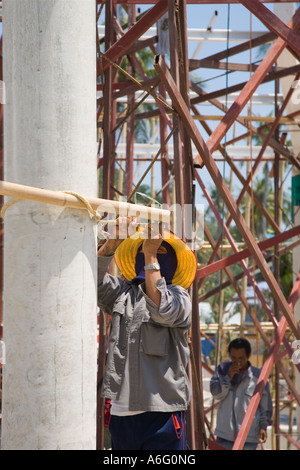 Male asian construction team of workmen assembling bamboo building structure scaffolding at reconstruction site on Ko Phi Phi Island, Krabi Province Stock Photo