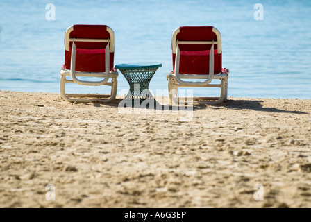 Lounge chairs and side table on beach, Boca Chica, Dominican Republic, 1/07 Stock Photo