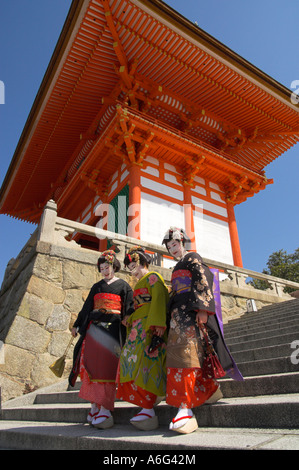 Japan Central Honshu Kansai Kyoto Kiyomizudera temple 3 geishas in traditional dress and shoes walking down a fly of stairs with Stock Photo