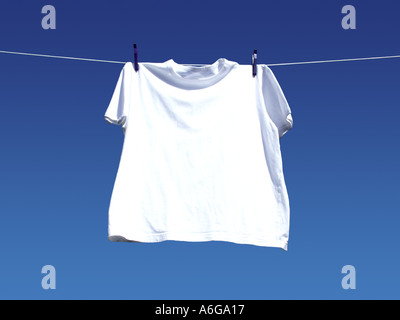 Blank white t-shirt hanging on the wooden background, with copy space ...
