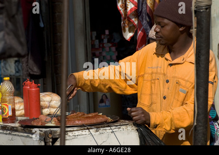 South Africa Johanesburg Alexandra Township street hawker frying saussages at street stall Stock Photo