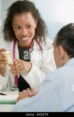 Senior doctor consulting with a patient after a medical exam Stock
