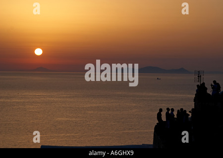 Sunset with sun setting in to the Aegean sea Stock Photo