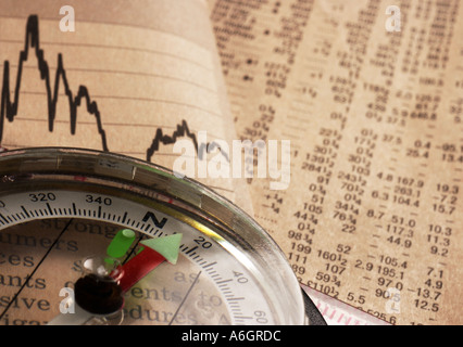 Close up of compass on financial newspaper Stock Photo