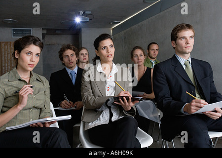 People making notes in a presentation Stock Photo