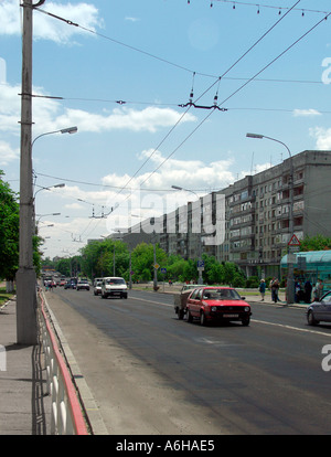 Looking down Sovetskaya Street with overhead trolleybus wires and past the university apartments on right in Gomel Belarus Stock Photo