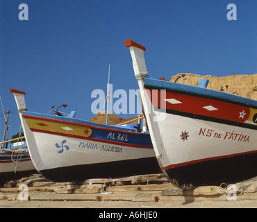 Portugal the Algarve, Olhos de Agua, brightly coloured fishing boats drawn up on the beach Stock Photo