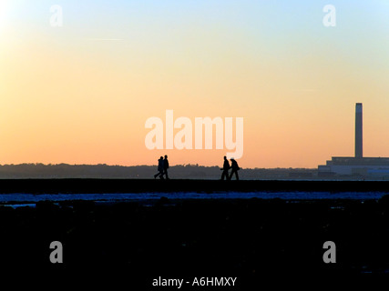 Two couples taking a sunset stroll at Hill Head, England Stock Photo
