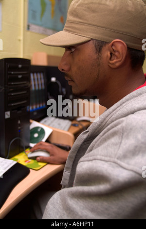 Young man working at a computer, London UK Stock Photo