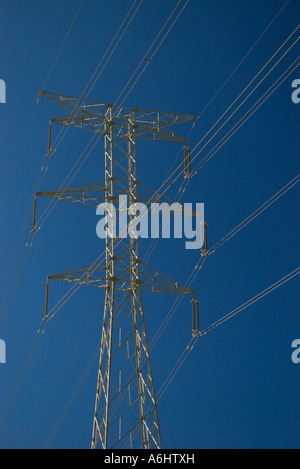 Electricty pylon against a clear blue sky Stock Photo