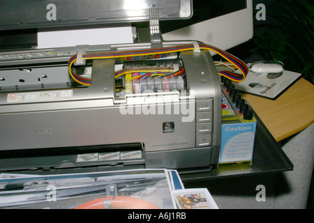 Close shot of cartridge replacement and supply pipes in a bulk ink supply system for inkjet printers. Stock Photo