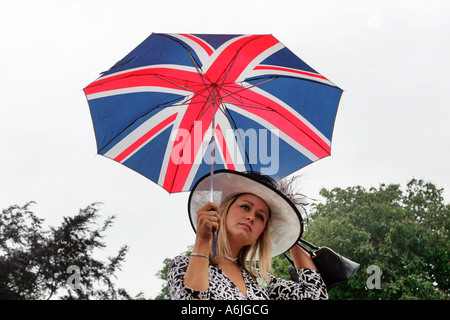 Woman holding an umbrella in British national colours, Royal Ascot at York, Great Britain Stock Photo